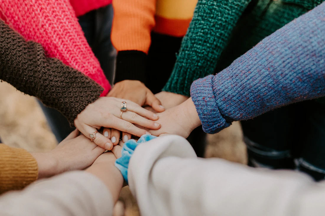 Hands coming together in a gesture of support