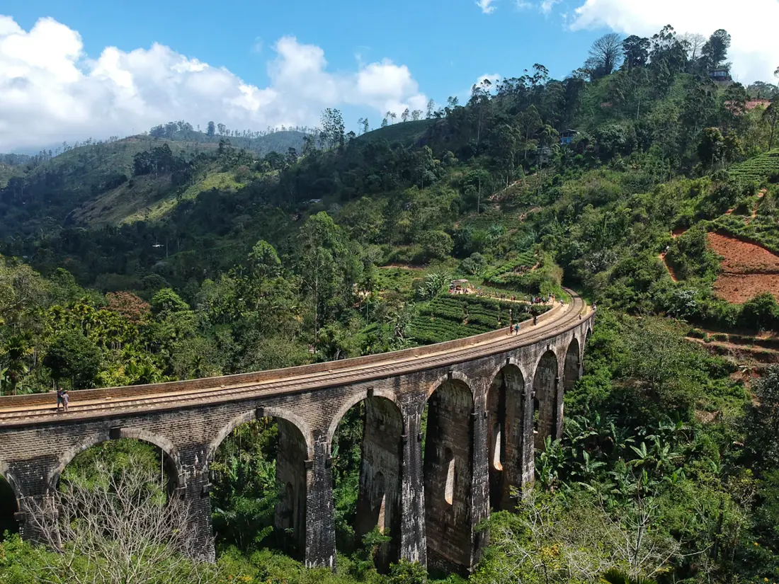 The Nine Arch Bridge surrounded by green hills in Sri Lanka